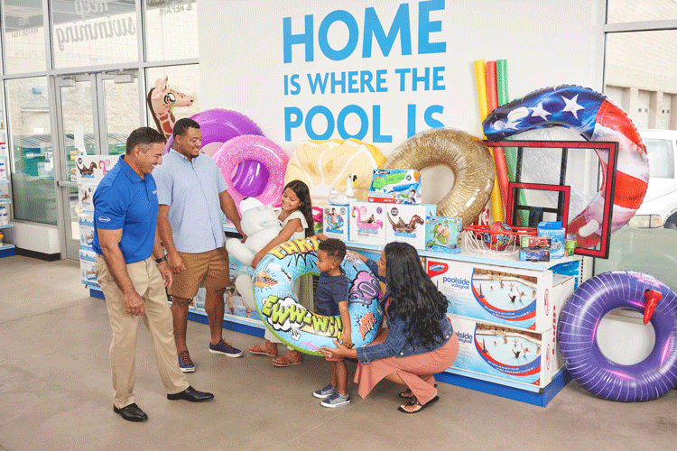 Leslie's associate helping a family find fun pool floats, toys, and games