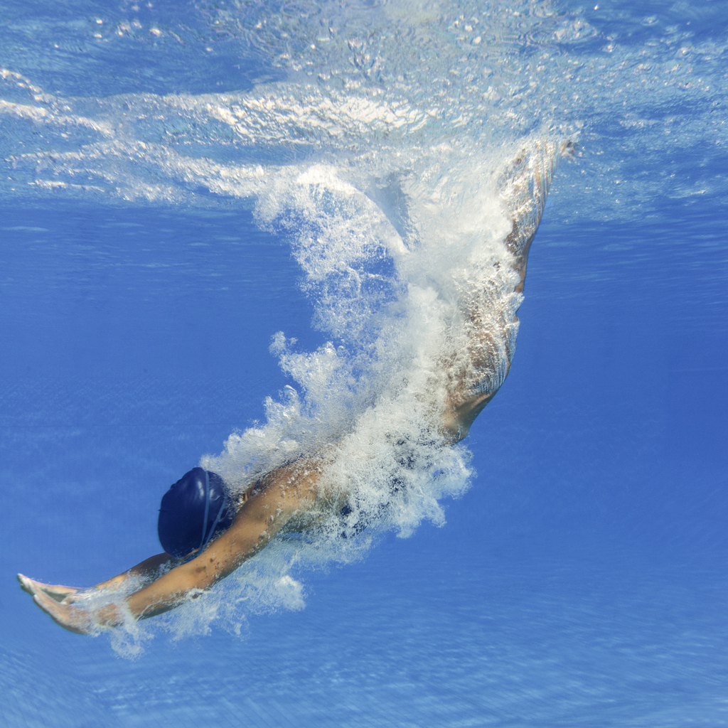 woman diving into pool