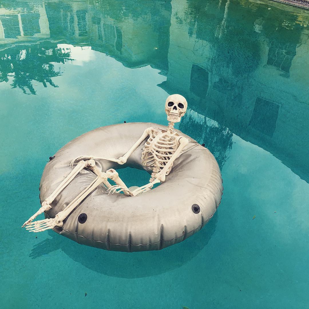 skeleton in a pool float