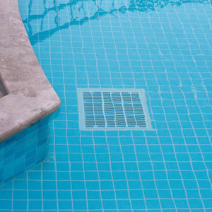 large square pool drain at the bottom of a pool
